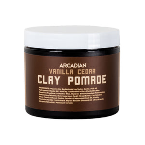 Arcadian Vanilla Cedar Clay Pomade, purkki valkoisella kannella ja ruskealla etiketillä edestäpäin.