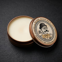 Reuzel Snorwax - open blik met zichtbare wax op donkere leisteen